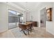 Dining room with modern lighting, wood floors, and access to the patio through sliding glass doors at 331 Josef Cir, Fort Lupton, CO 80621
