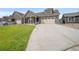 Exterior view of a home with a spacious concrete driveway leading up to a charming two-car garage at 331 Josef Cir, Fort Lupton, CO 80621
