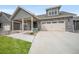 Exterior view of a home with a spacious concrete driveway leading up to a charming two-car garage at 331 Josef Cir, Fort Lupton, CO 80621