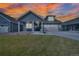 Charming home with a two-car garage, covered porch, and inviting curb appeal at sunset at 331 Josef Cir, Fort Lupton, CO 80621
