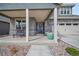 Inviting covered front porch with stone accents, seating, and a charming entrance at 331 Josef Cir, Fort Lupton, CO 80621