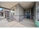 Inviting covered front porch with stone accents, seating, and a charming entrance at 331 Josef Cir, Fort Lupton, CO 80621