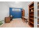 Bright home office with two built-in desks, bookcase, ample lighting, and hardwood floors for a productive workspace at 331 Josef Cir, Fort Lupton, CO 80621