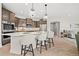 Kitchen featuring a large island with seating, stainless steel appliances, and decorative lighting at 331 Josef Cir, Fort Lupton, CO 80621