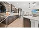 Kitchen with stainless steel appliances, quartz countertops, and island seating at 331 Josef Cir, Fort Lupton, CO 80621