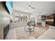 Bright open-concept living room with fireplace, hardwood floors, and open view of kitchen at 331 Josef Cir, Fort Lupton, CO 80621