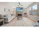 Bright living room with fireplace, large window, hardwood floors, and modern decor at 331 Josef Cir, Fort Lupton, CO 80621