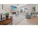 Bright living room with fireplace, large window, hardwood floors, and modern decor at 331 Josef Cir, Fort Lupton, CO 80621