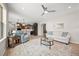 Bright living room featuring wood floors, neutral colors, and an open floor plan to the kitchen at 331 Josef Cir, Fort Lupton, CO 80621