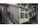 Exterior view of condo showing staircase, large windows, and neutral siding at 13854 E Lehigh Ave # D, Aurora, CO 80014