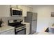 Well-lit kitchen with stainless steel appliances and white cabinetry at 13854 E Lehigh Ave # D, Aurora, CO 80014