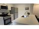 Updated kitchen with stainless steel appliances and quartz counters at 13854 E Lehigh Ave # D, Aurora, CO 80014