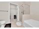 Modern bathroom featuring a tiled walk-in shower, large soaking tub, and a door to a walk-in closet at 13598 Via Varra # 301, Broomfield, CO 80020
