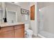 A cozy bathroom features a vanity, framed artwork, and a glass door shower at 13598 Via Varra # 301, Broomfield, CO 80020