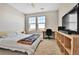 Bedroom with large windows, a workspace, and a ceiling fan at 13598 Via Varra # 301, Broomfield, CO 80020