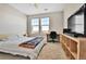 Bright bedroom featuring natural light, a ceiling fan, a work desk, and neutral-colored walls at 13598 Via Varra # 301, Broomfield, CO 80020