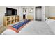 Bright bedroom featuring shelving, a view into another room, and access to a closet at 13598 Via Varra # 301, Broomfield, CO 80020