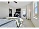 Bright bedroom with ceiling fan, desk and TV, and comfortable carpeted floors leading to a bathroom and living space at 13598 Via Varra # 301, Broomfield, CO 80020