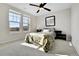 Bright bedroom featuring carpet floors, double windows, ceiling fan and a decorative wall mirror at 13598 Via Varra # 301, Broomfield, CO 80020
