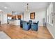 Open dining area with hardwood floors and modern light fixture at 13598 Via Varra # 301, Broomfield, CO 80020