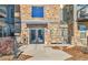 Exterior view of the building's entrance, featuring stone accents and well-lit walkway at 13598 Via Varra # 301, Broomfield, CO 80020