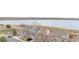 Aerial view showcasing a row of houses with a stunning lake in the background at 649 Mockingbird St, Brighton, CO 80601