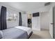 Bright bedroom featuring a cozy bed, ample natural light, and an organized walk-in closet at 649 Mockingbird St, Brighton, CO 80601