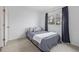 A bright bedroom with a large window, comfortable bed, and a neutral color scheme at 649 Mockingbird St, Brighton, CO 80601