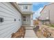 Stylish two-story home entrance with well-manicured yard at 649 Mockingbird St, Brighton, CO 80601