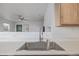 Bright kitchen featuring a stainless steel sink, a marble counter top and wood cabinets at 649 Mockingbird St, Brighton, CO 80601