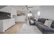 Bright living room features hardwood floors, a comfortable gray sofa and open concept floor plan at 649 Mockingbird St, Brighton, CO 80601