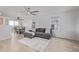 Bright living room with hardwood floors, a ceiling fan, and a comfortable gray sofa at 649 Mockingbird St, Brighton, CO 80601