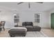 Bright living room features hardwood floors, a comfortable gray sofa and lots of natural light at 649 Mockingbird St, Brighton, CO 80601