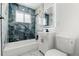 Elegant bathroom with luxurious tilework, modern fixtures, a bathtub, and a stylish vanity at 4701 E Jewell Ave, Denver, CO 80222
