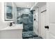 Stunning bathroom featuring beautifully tiled shower with modern fixtures and stylish vanity at 4701 E Jewell Ave, Denver, CO 80222
