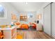 Colorful and bright bedroom features a dedicated study area, a closet and hardwood floors at 4701 E Jewell Ave, Denver, CO 80222