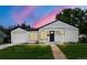 Charming single-story home featuring a black front door, attached garage, and freshly cut lawn at 4701 E Jewell Ave, Denver, CO 80222