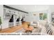 Bright open-concept living room flows into a modern kitchen with a breakfast bar and hardwood floors at 4701 E Jewell Ave, Denver, CO 80222