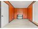 Cozy room featuring a fireplace, wood paneling and tile flooring at 4701 E Jewell Ave, Denver, CO 80222