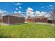 Brick detached garage and home with grassy backyard at 5510 Troy St, Denver, CO 80239