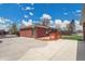 Wide backyard view with a patio area and brick home at 5510 Troy St, Denver, CO 80239