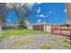 Brick home with large backyard, patio, and detached garage at 5510 Troy St, Denver, CO 80239
