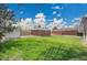 Brick home, detached garage, and shed in large backyard at 5510 Troy St, Denver, CO 80239