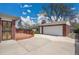 Detached garage and brick home with backyard patio at 5510 Troy St, Denver, CO 80239
