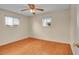 Inviting bedroom with hardwood floors, dual windows, and a ceiling fan offering a cozy and comfortable retreat at 5510 Troy St, Denver, CO 80239