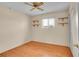 Cozy bedroom with hardwood floors, a ceiling fan, and abundant natural light providing a relaxing atmosphere at 5510 Troy St, Denver, CO 80239