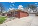 Charming brick home with a well-maintained front yard and detached garage at 5510 Troy St, Denver, CO 80239