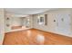 Bright living room with hardwood floors, a large window, and ample space, perfect for entertaining guests at 5510 Troy St, Denver, CO 80239
