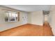 Spacious living room with hardwood flooring, abundant natural light, and neutral wall paint throughout the space at 5510 Troy St, Denver, CO 80239