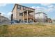 Expansive backyard with a patio, deck, and well-maintained lawn, great for Gathering gatherings at 2042 Shadow Creek Dr, Castle Rock, CO 80104